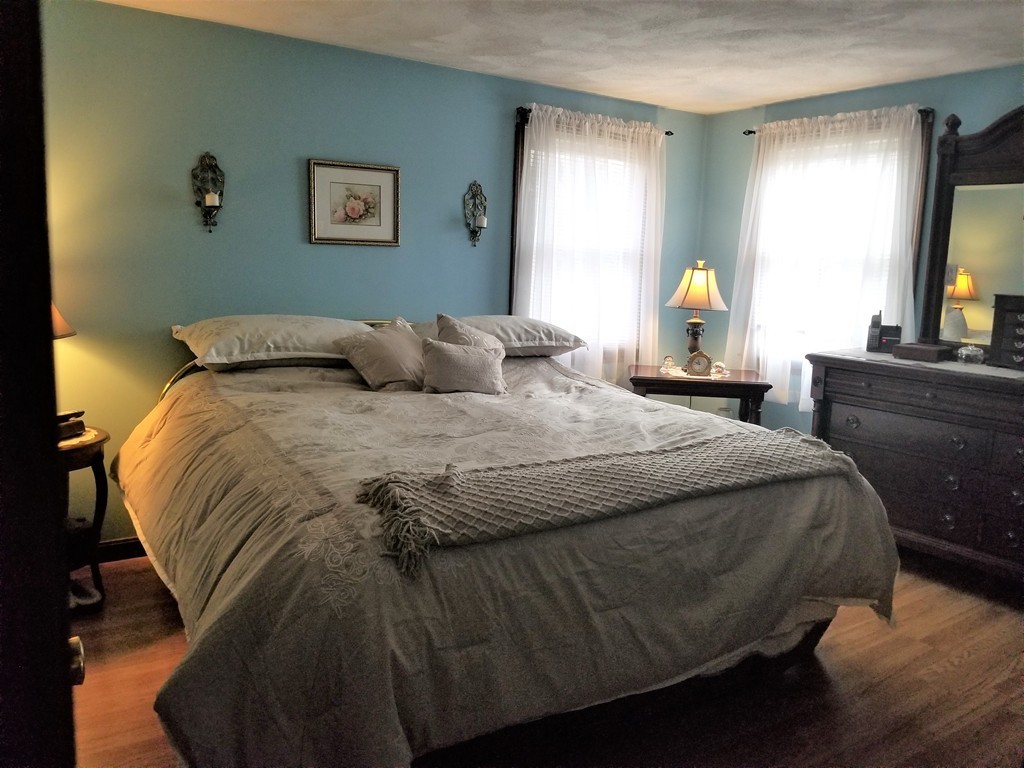 22 Wyman Road Billerica, MA 01821 - Photo 10 of 29 a bedroom with a bed and wooden floor