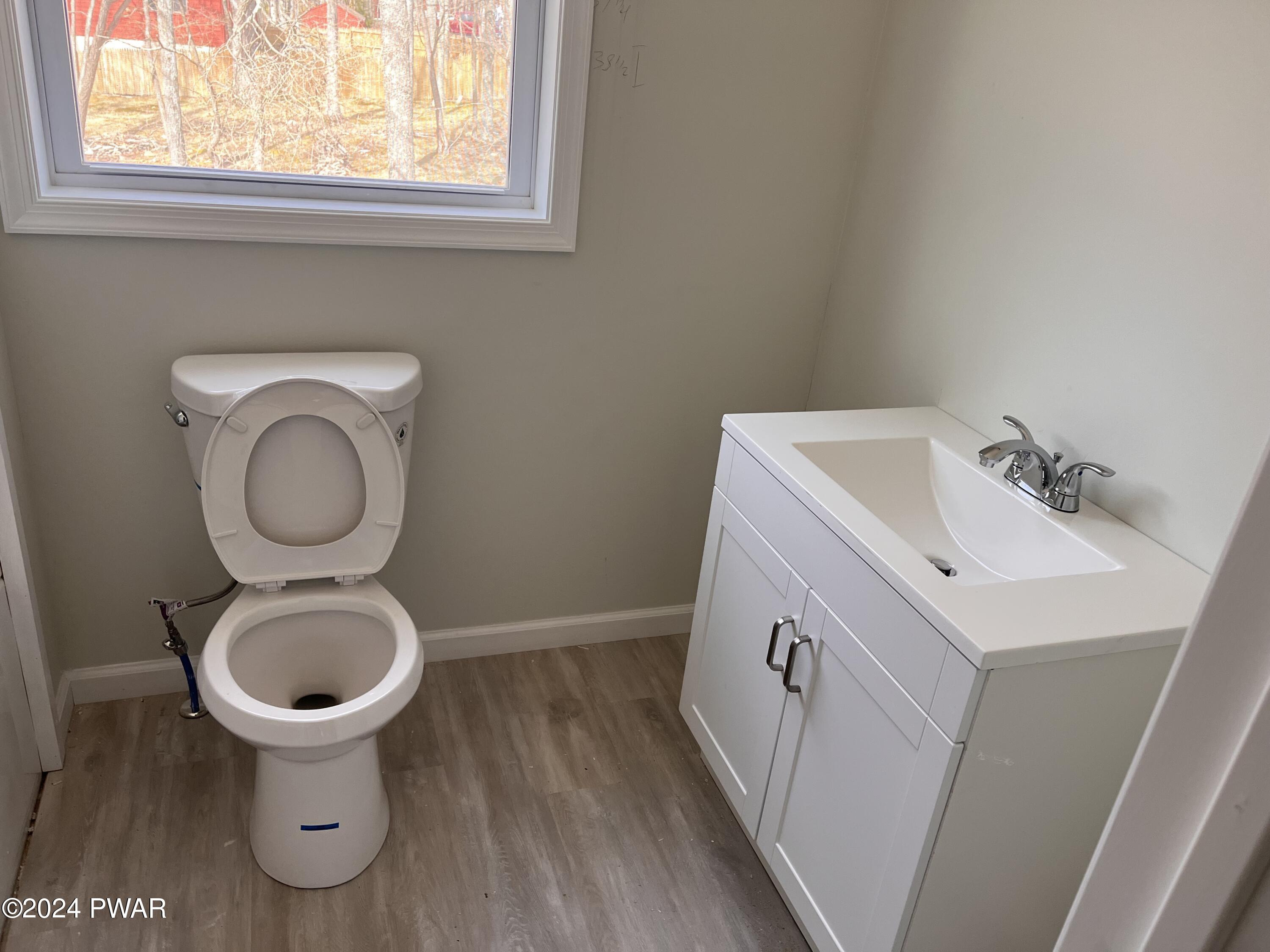 128 Stonehenge Road Milford, PA 18337 - Photo 13 of 14 a bathroom with a toilet sink and mirror