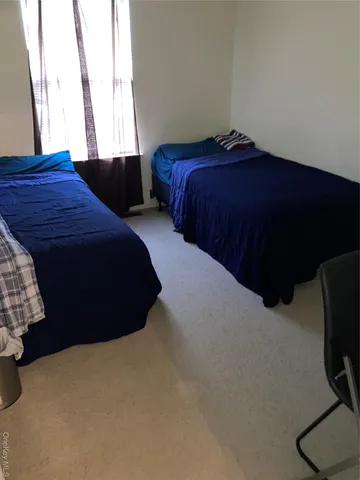 a bedroom with a bed and dresser