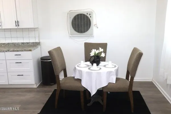 a dining room with furniture and wooden floor