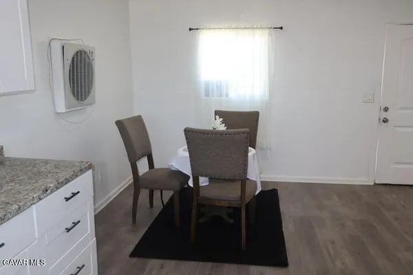 a view of a workspace with furniture and bathroom