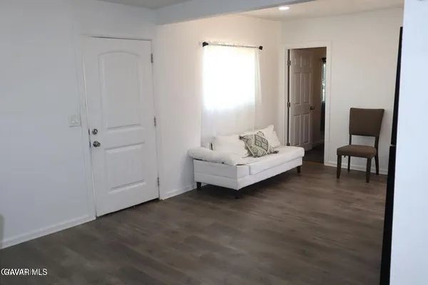 a spacious bedroom with a bed and a chair