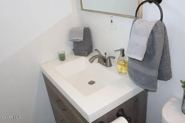 a bathroom with a sink and mirror