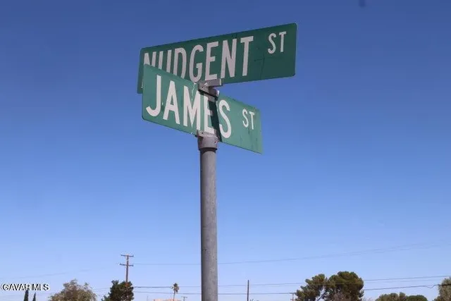 a street sign on a wall next to a road
