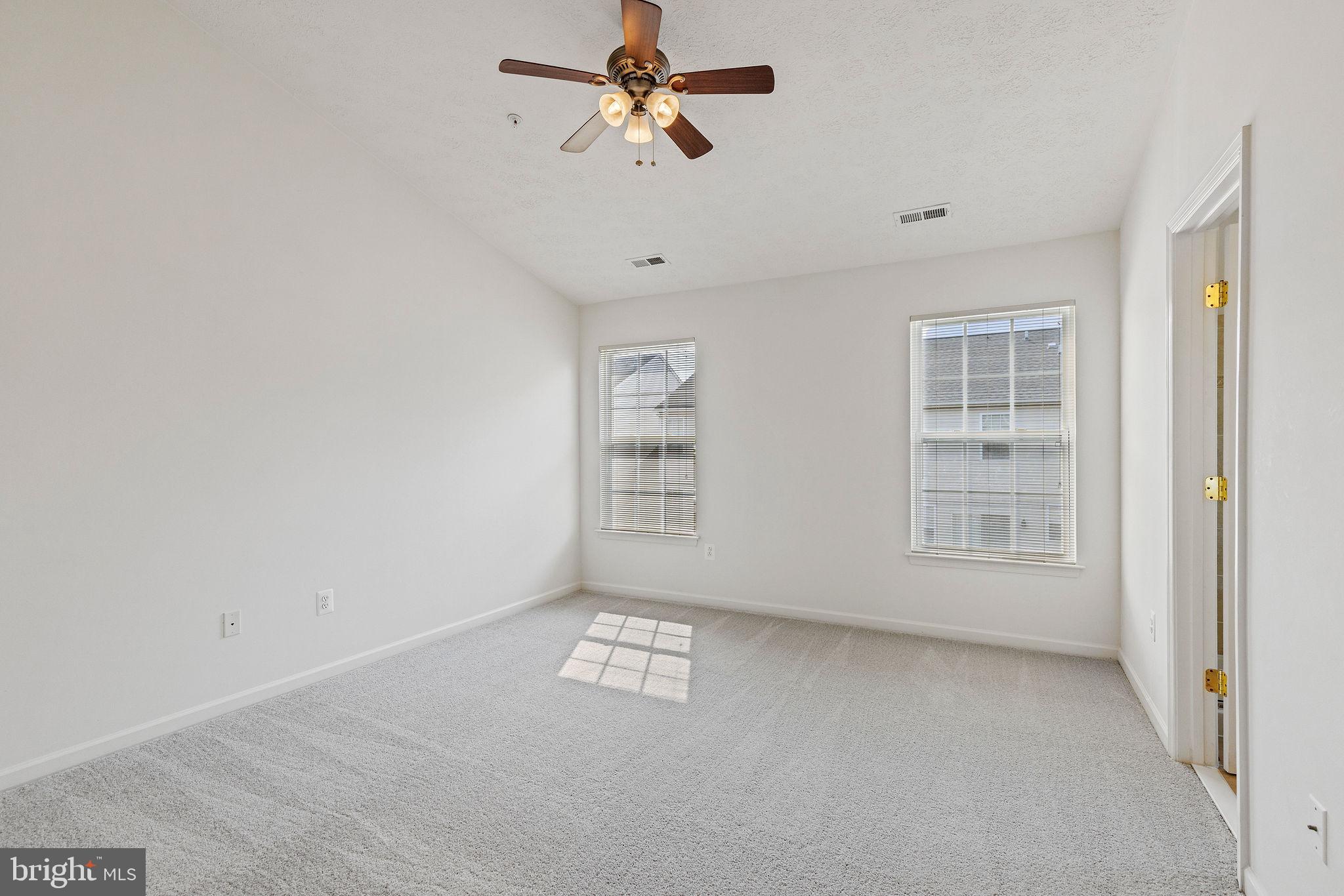 9717 Biggs Road Middle River, MD 21220 - Photo 15 of 48 an empty room with windows and fan