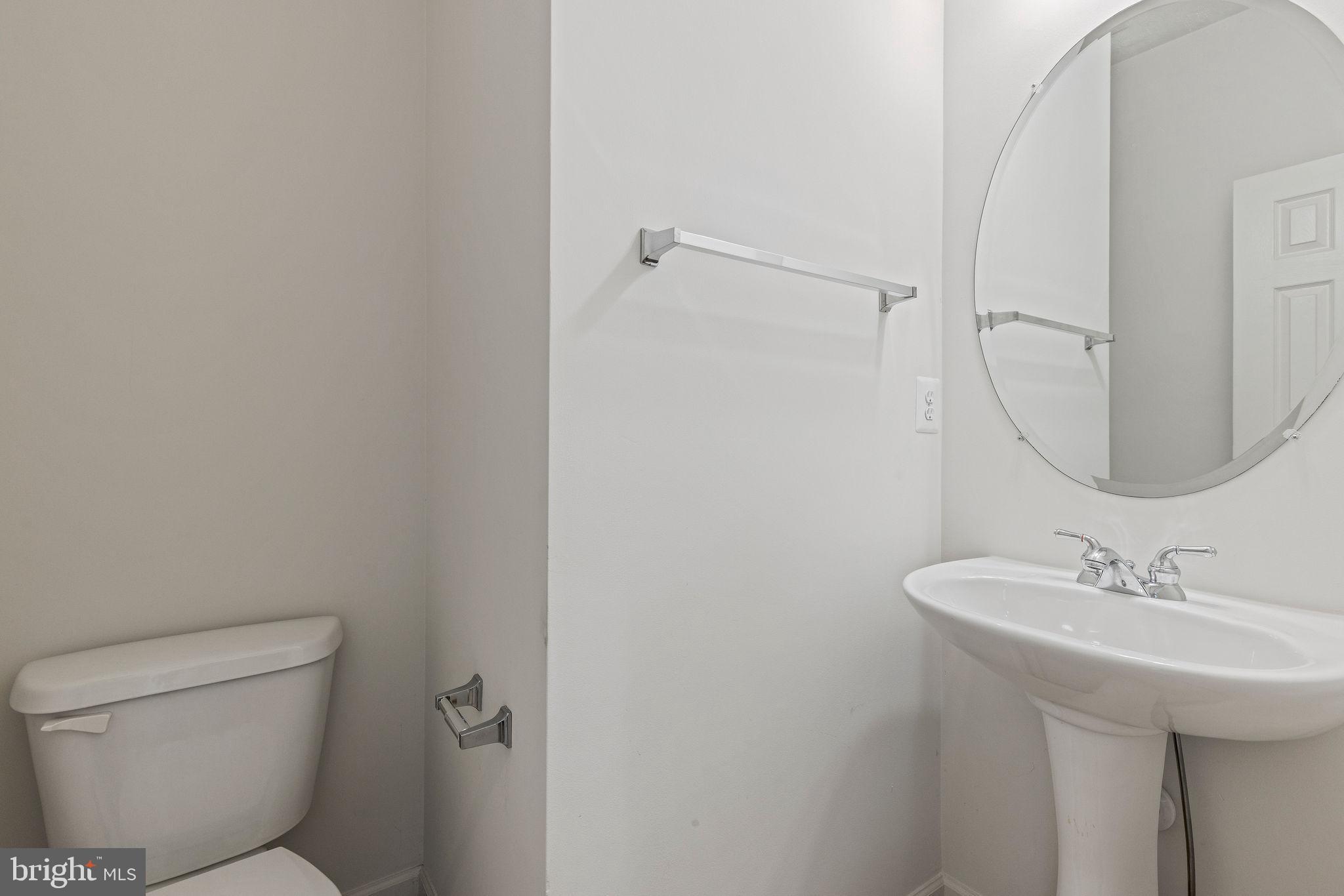 9717 Biggs Road Middle River, MD 21220 - Photo 7 of 48 a bathroom with a sink toilet and a mirror