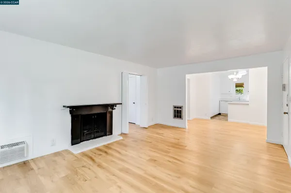 a view of empty room with a fireplace