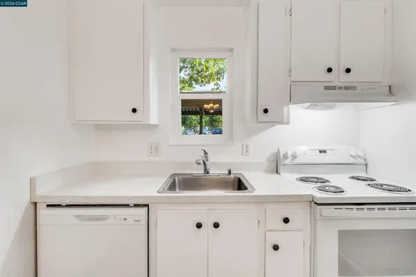 a kitchen with appliances cabinets and a window