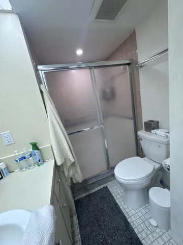 a bathroom with a toilet and a shower