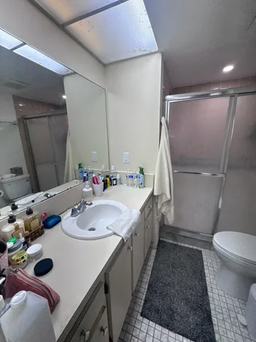 a bathroom with a sink a toilet and a mirror