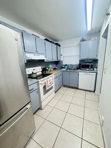 a kitchen with stainless steel appliances granite countertop a stove top oven a sink a counter top space and cabinets