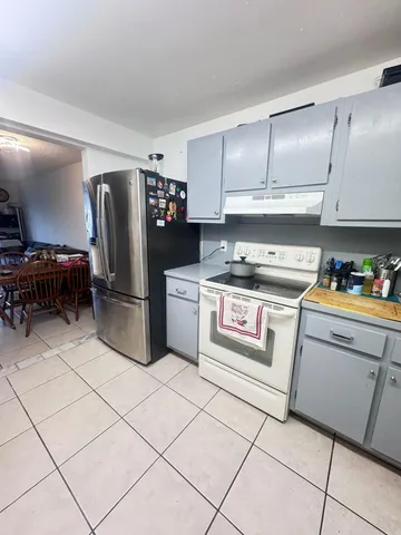 a kitchen with stainless steel appliances a refrigerator sink and cabinets