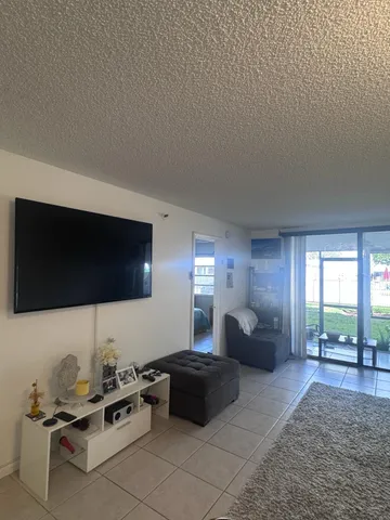 a bedroom with furniture and a flat screen tv