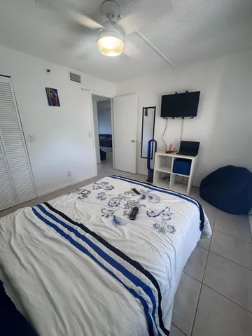 a bedroom with a bed and a television