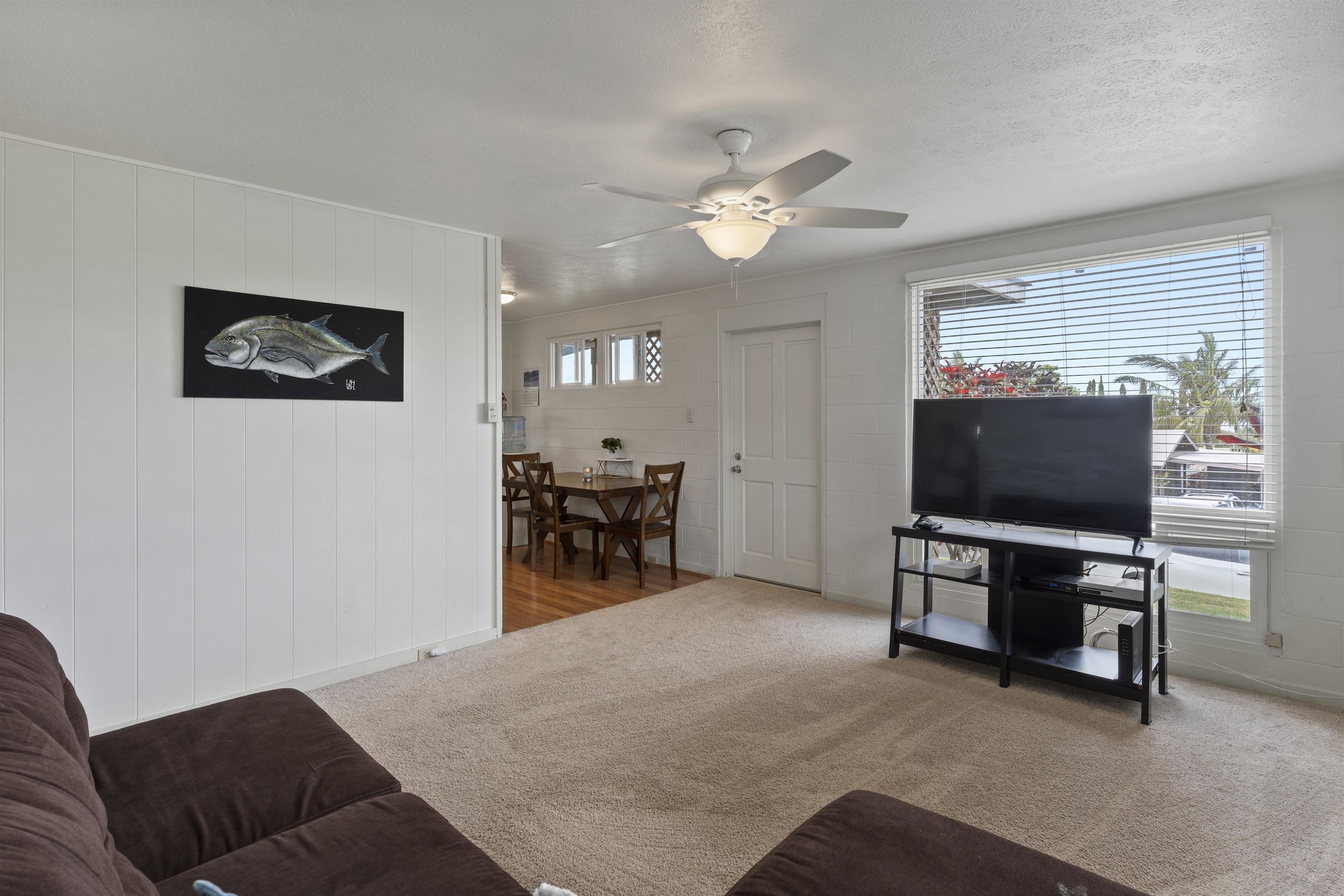 27 Maha Road, Unit 7 Makawao, HI 96768 - Photo 3 of 21 a living room with furniture and a flat screen tv