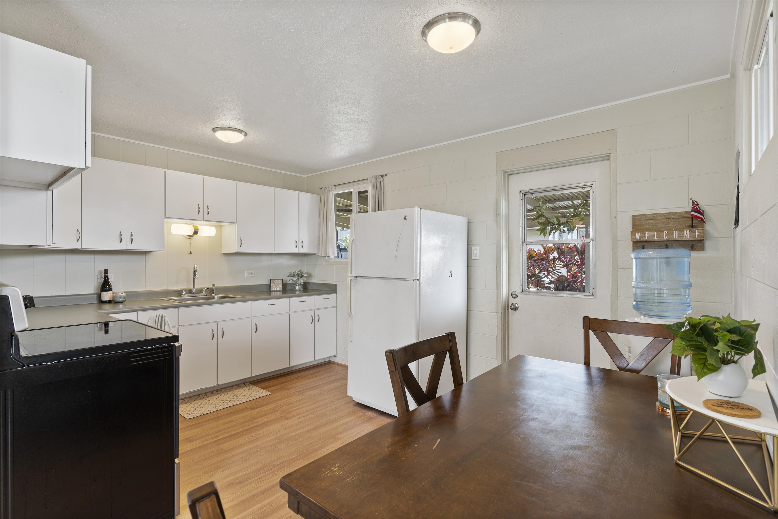 27 Maha Road, Unit 7 Makawao, HI 96768 - Photo 7 of 21 a kitchen with granite countertop cabinets stainless steel appliances and a dining table