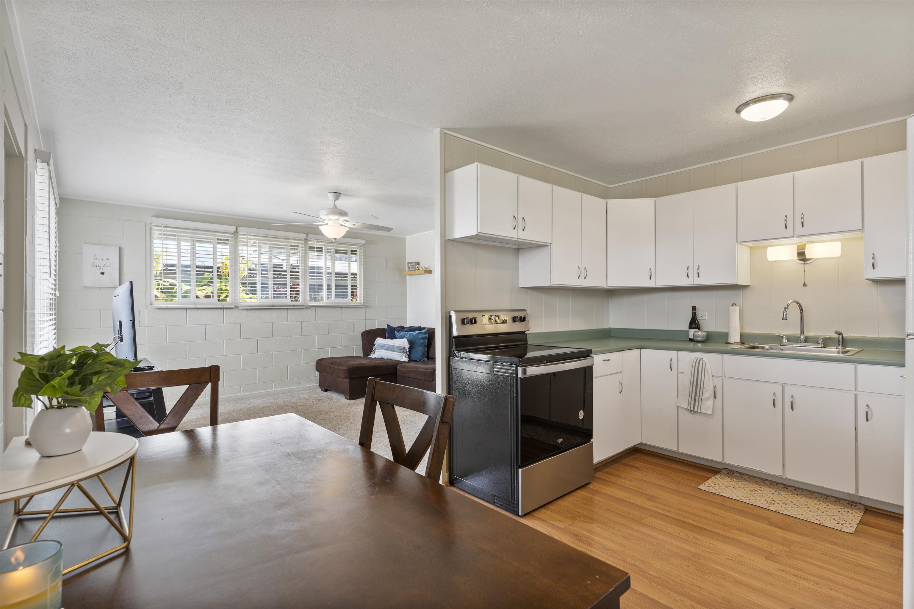 27 Maha Road, Unit 7 Makawao, HI 96768 - Photo 9 of 21 a kitchen with granite countertop white cabinets and white appliances