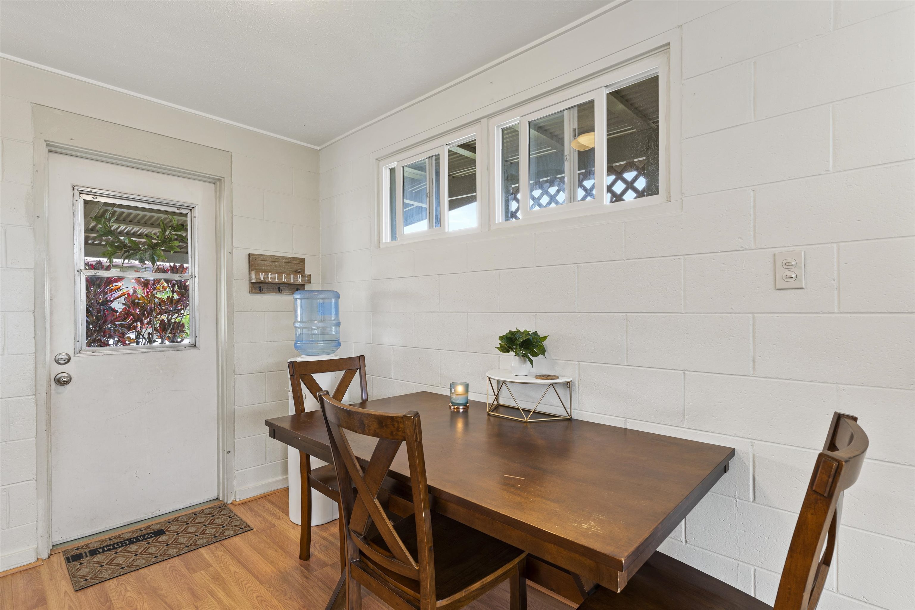 27 Maha Road, Unit 7 Makawao, HI 96768 - Photo 10 of 21 a view of a dining room with furniture and wooden floor