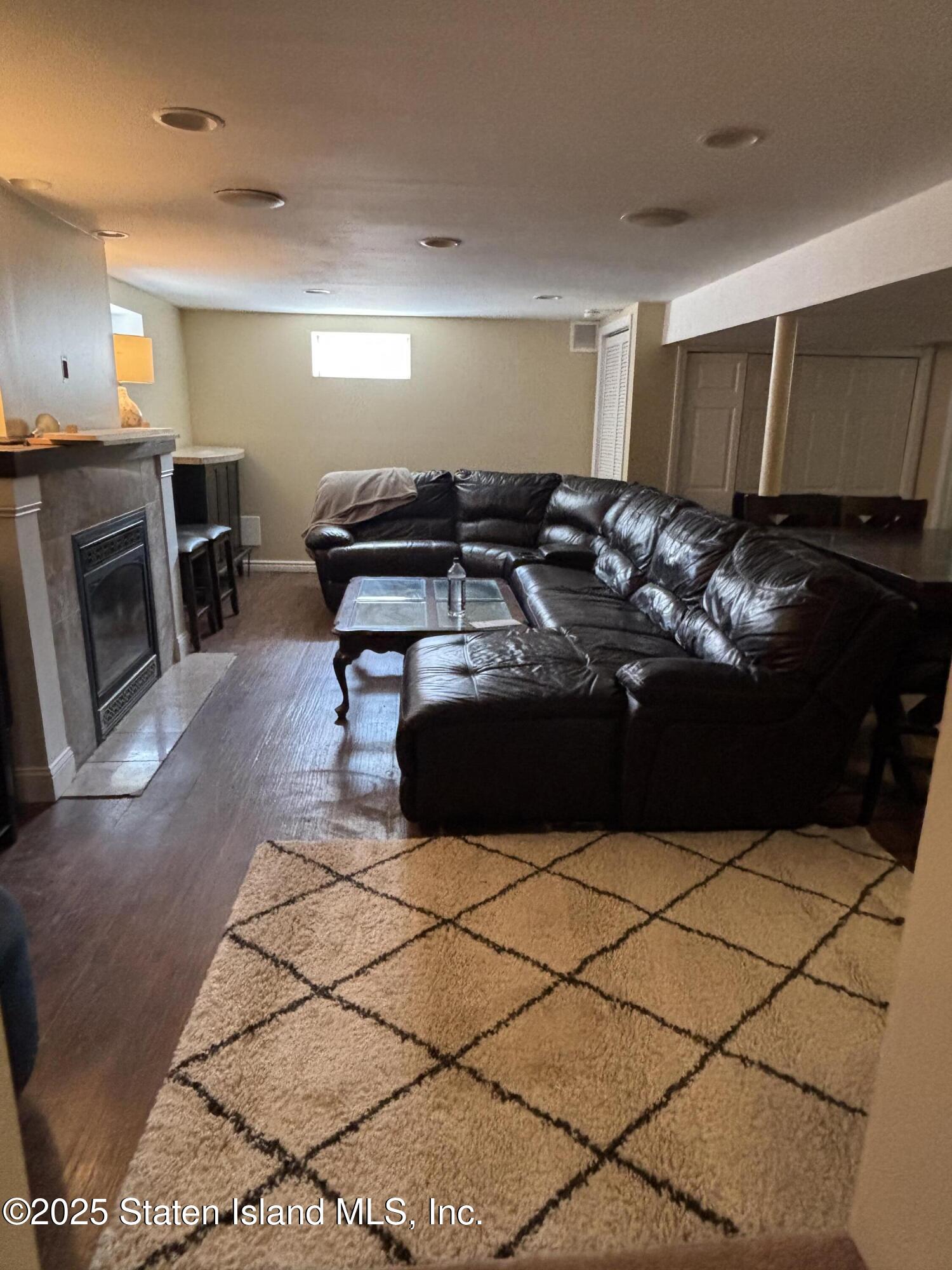 16 Ridgecrest Avenue Staten Island, NY 10312 - Photo 13 of 20 a bed room with a bed furniture and a fireplace