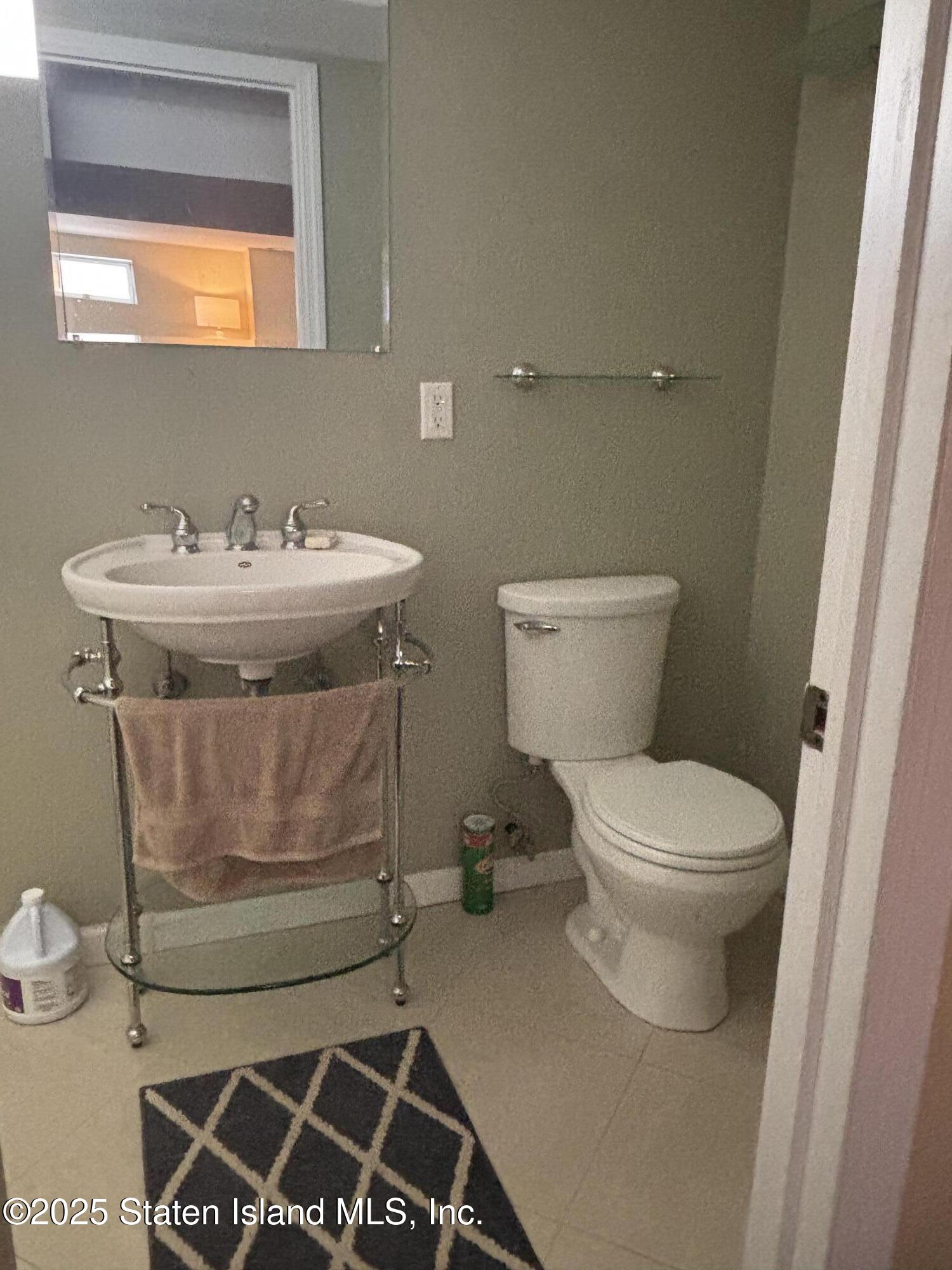 16 Ridgecrest Avenue Staten Island, NY 10312 - Photo 17 of 20 a bathroom with a toilet and a sink