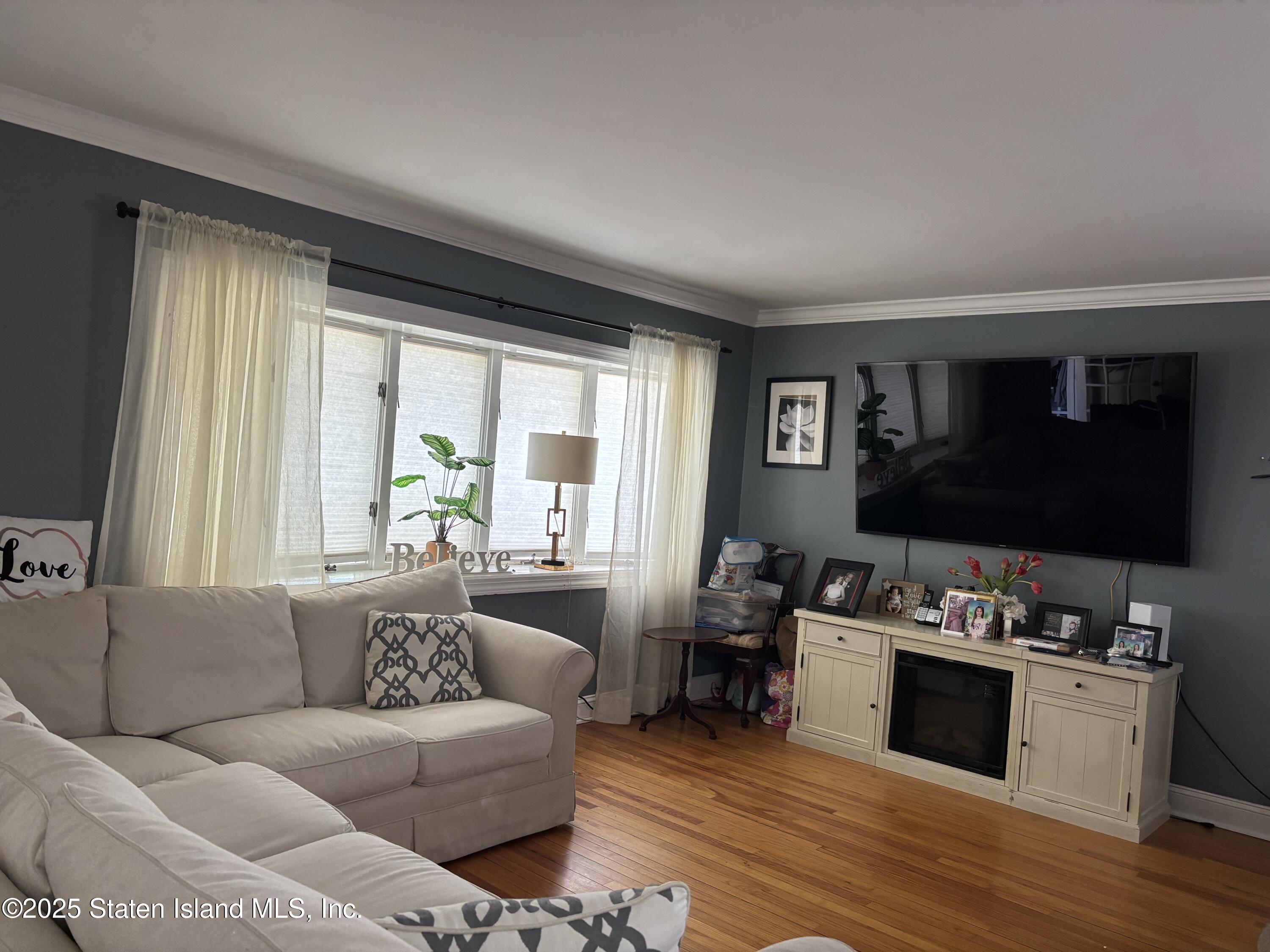 16 Ridgecrest Avenue Staten Island, NY 10312 - Photo 2 of 20 a living room with furniture and a flat screen tv