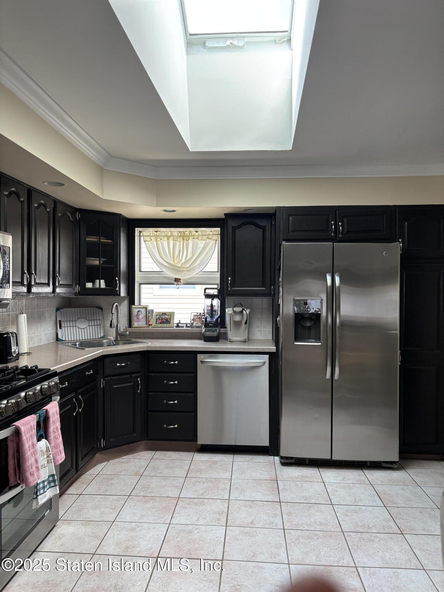 16 Ridgecrest Avenue Staten Island, NY 10312 - Photo 4 of 20 a kitchen with granite countertop a refrigerator and a sink