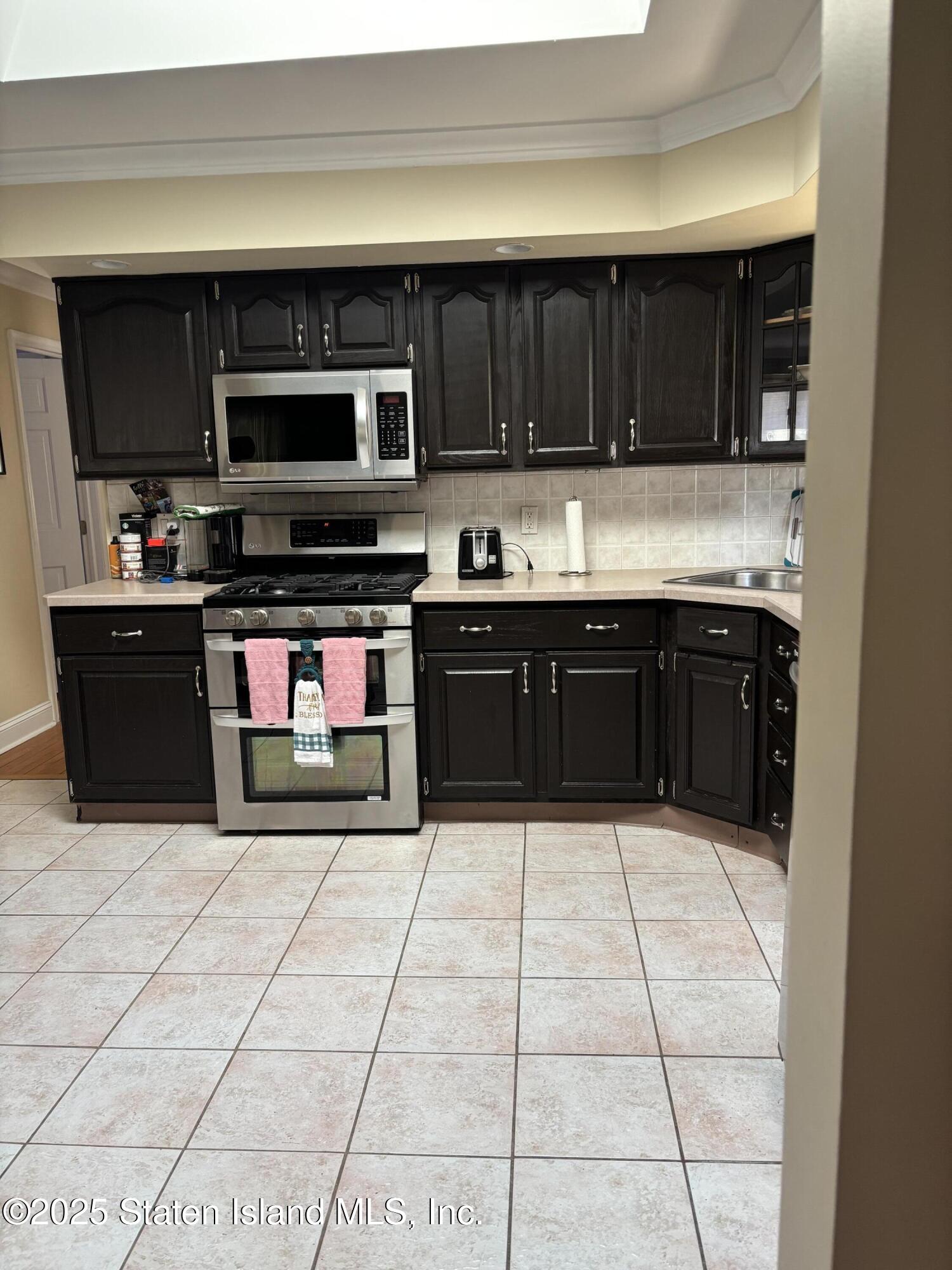 16 Ridgecrest Avenue Staten Island, NY 10312 - Photo 5 of 20 a kitchen with stainless steel appliances granite countertop a stove and a cabinets