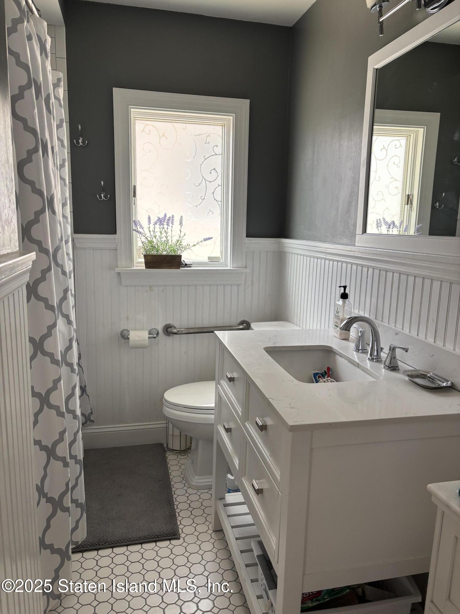 16 Ridgecrest Avenue Staten Island, NY 10312 - Photo 7 of 20 a bathroom with a sink toilet and window