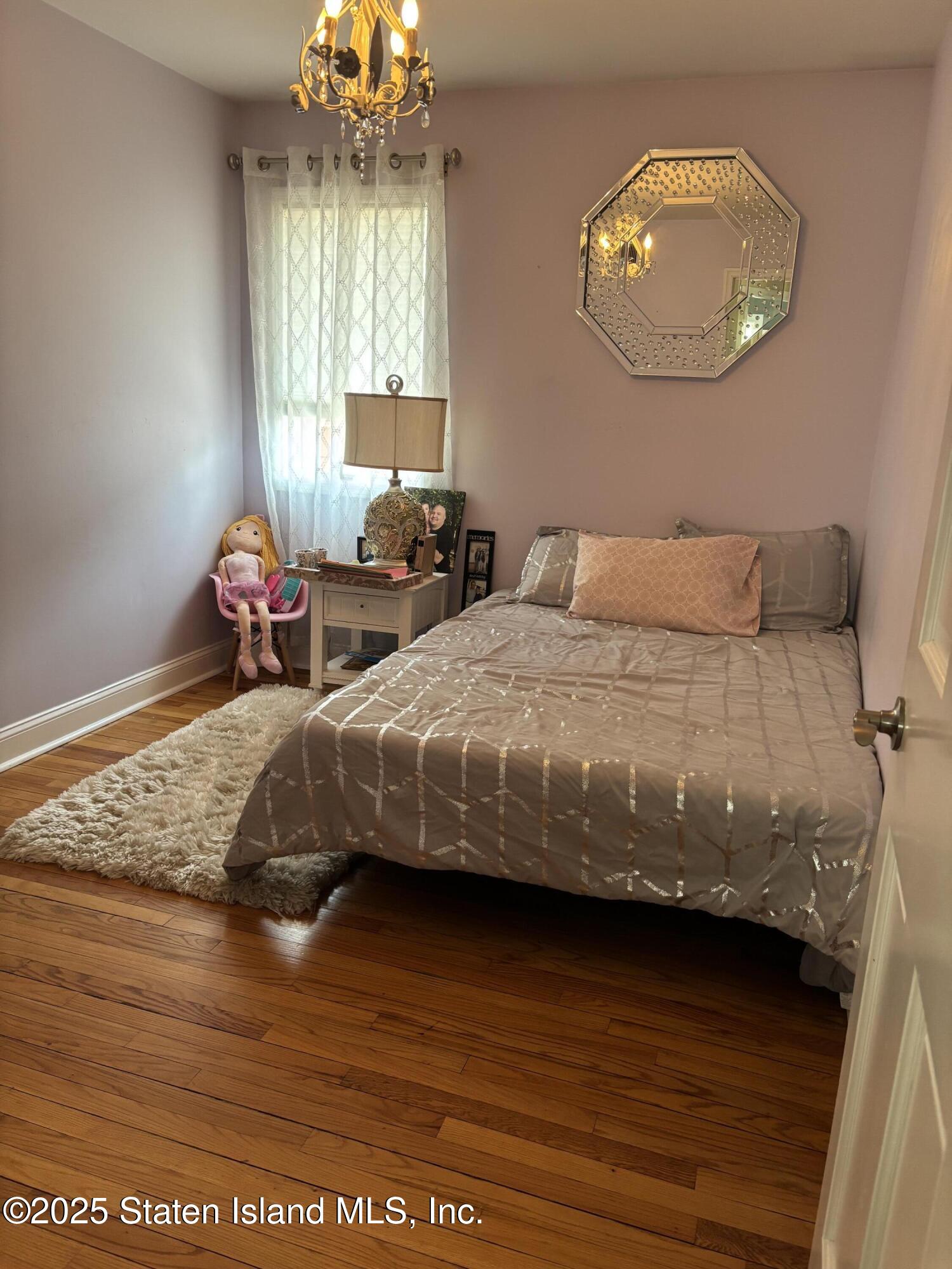 16 Ridgecrest Avenue Staten Island, NY 10312 - Photo 8 of 20 a bedroom with a bed and window