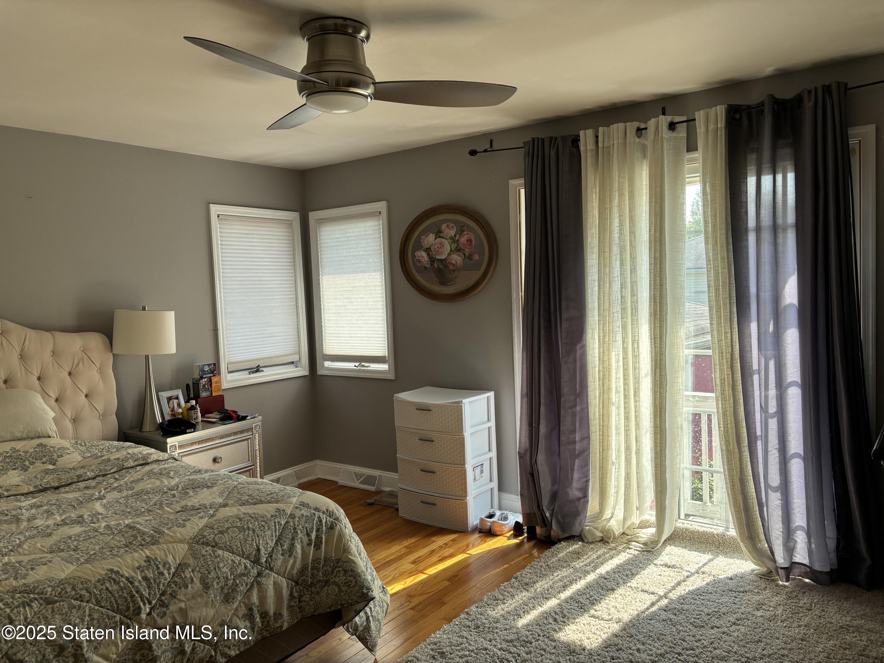 16 Ridgecrest Avenue Staten Island, NY 10312 - Photo 9 of 20 a bedroom with a bed and a chandelier