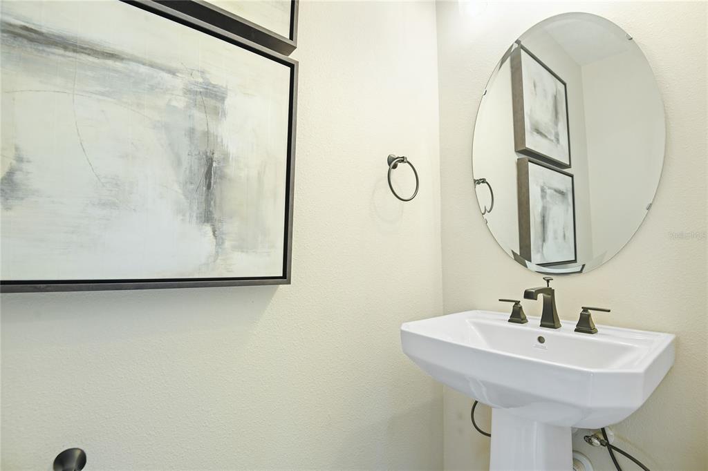 3633 Sublett Loop Tavares, FL 32778 - Photo 11 of 31 a bathroom with a sink and a mirror