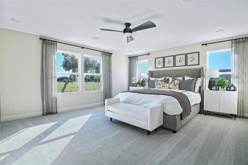 3633 Sublett Loop Tavares, FL 32778 - Photo 13 of 31 a spacious bedroom with a bed and a window