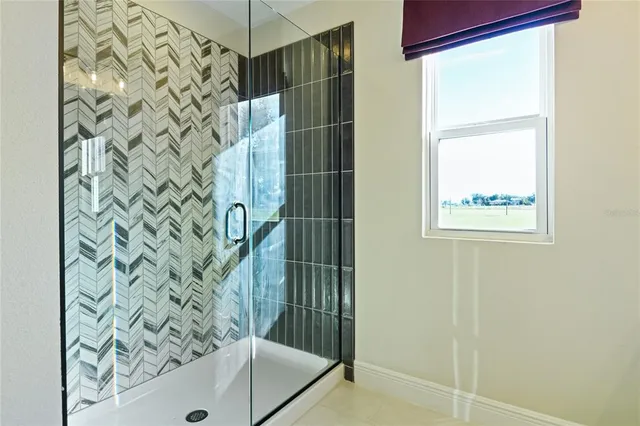 a bathroom with a shower and a sink