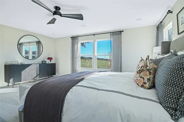 a bedroom with a large bed and a chandelier