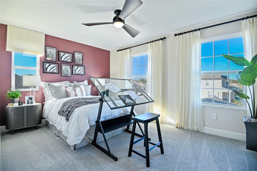 3633 Sublett Loop Tavares, FL 32778 - Photo 19 of 31 a bedroom with a bed and a chair