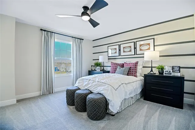 a spacious bedroom with a bed and a window