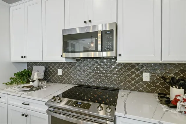 a kitchen with a stove and cabinets