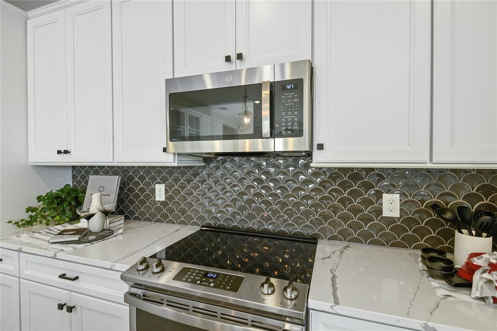 3633 Sublett Loop Tavares, FL 32778 - Photo 6 of 31 a kitchen with a stove and cabinets