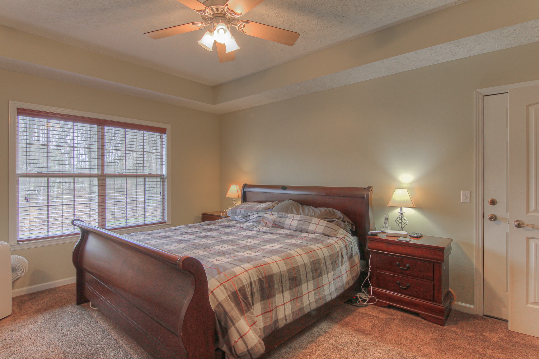 228 Espy Road Manchester, TN 37355 - Photo 13 of 46 a bedroom with a bed and a chandelier