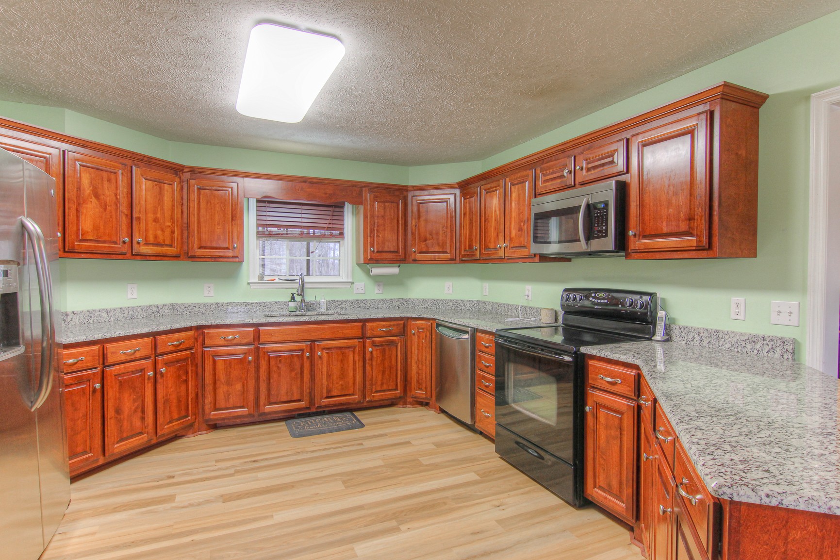 228 Espy Road Manchester, TN 37355 - Photo 8 of 46 a kitchen with stainless steel appliances granite countertop wooden cabinets a stove top oven a sink and dishwasher