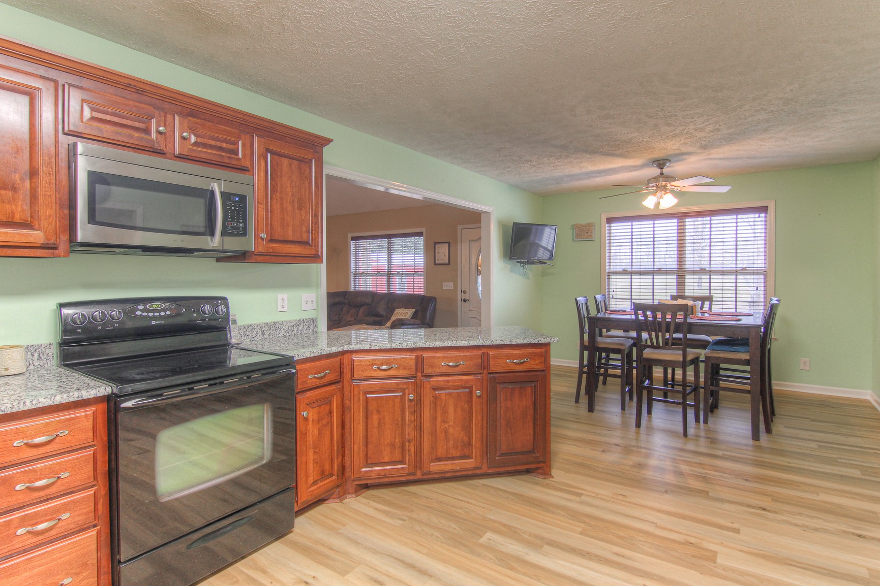 228 Espy Road Manchester, TN 37355 - Photo 9 of 46 a kitchen with stainless steel appliances granite countertop sink stove top oven and cabinets