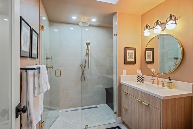 a bathroom with a sink mirror and vanity