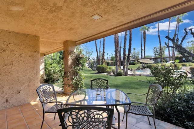 a view of a chairs and table in patio