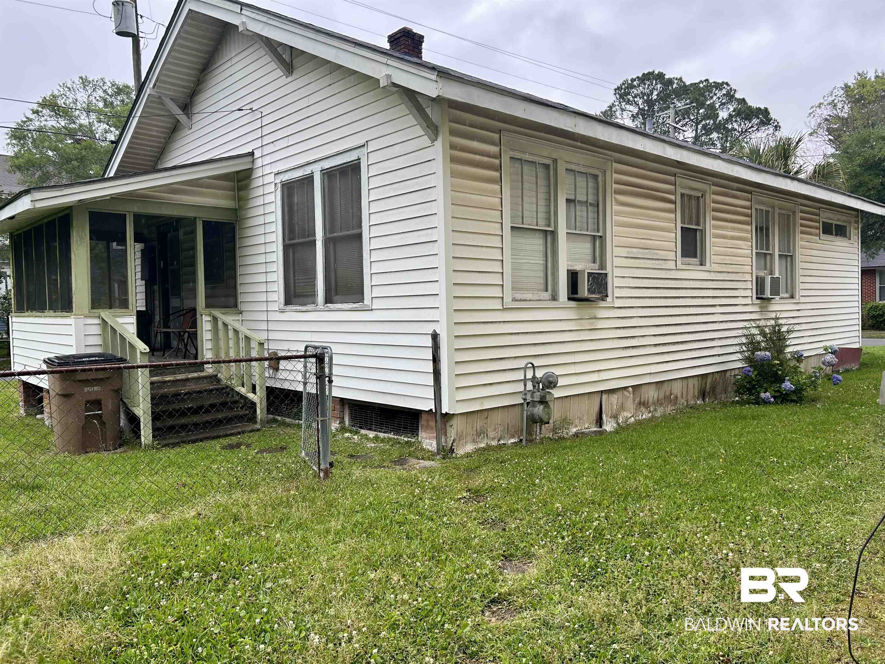 302 Stocking Street Mobile, AL 36604 - Photo 4 of 31 White siding exterior with a screened porch and gabled roofline