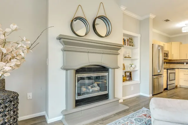 a living room with furniture a fireplace and a chandelier