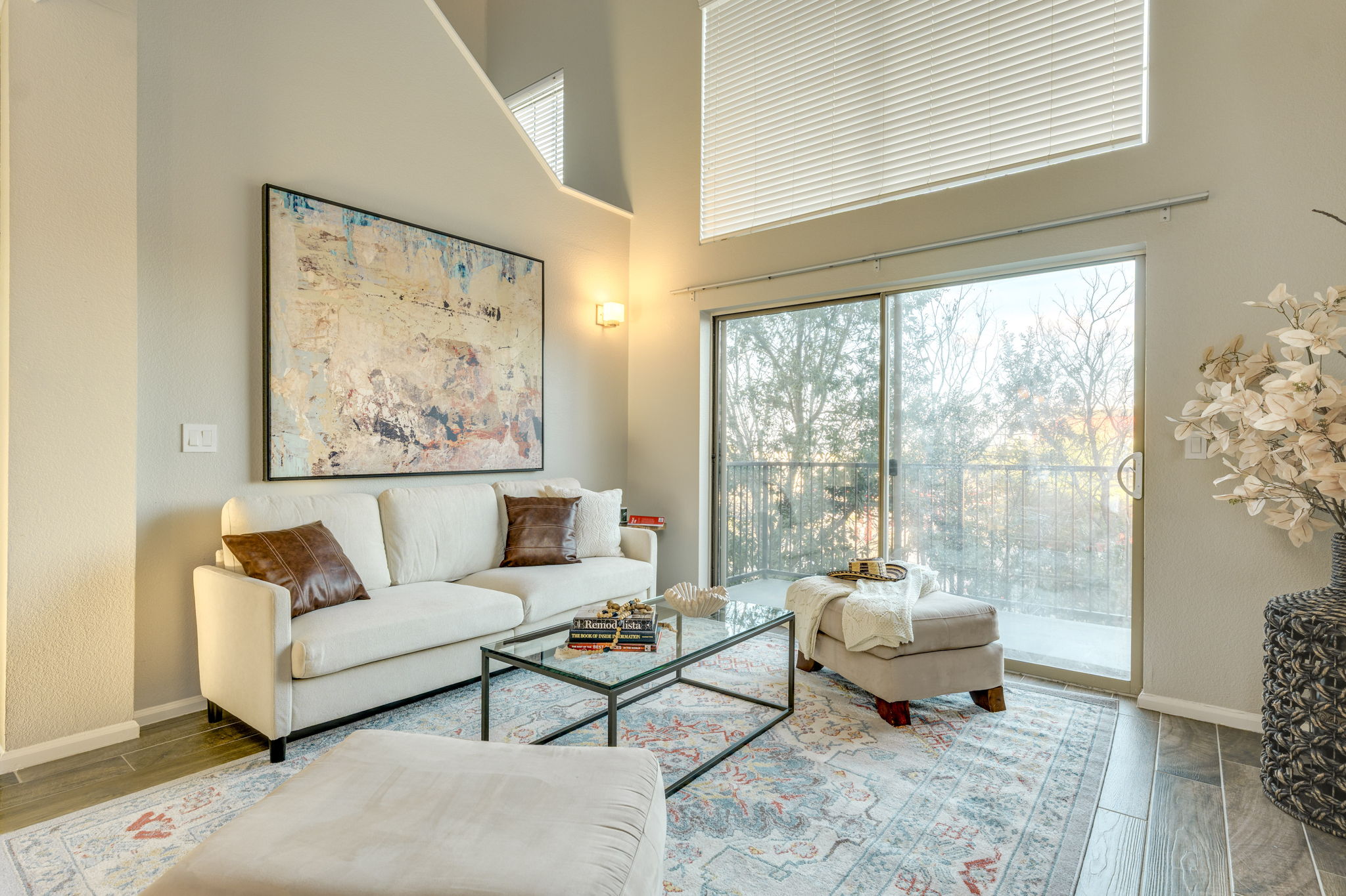 11203 Ranch Road 2222, Unit 901 Austin, TX 78732 - Photo 14 of 40 Living room with plenty of natural light, a high ceiling, and wood finished floors