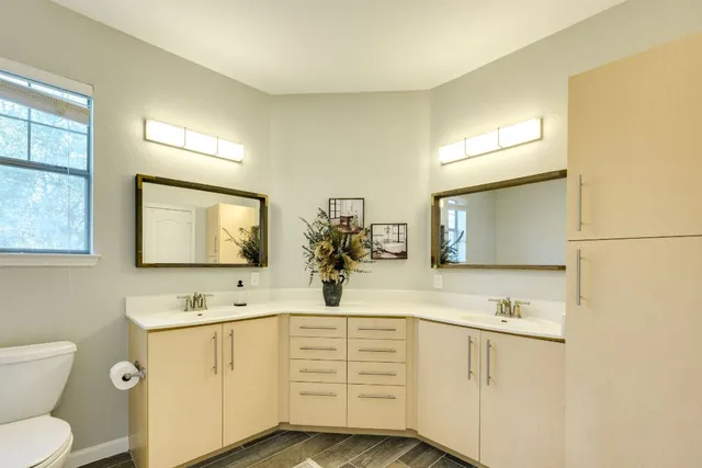 a bathroom with a sink vanity granite and toilet
