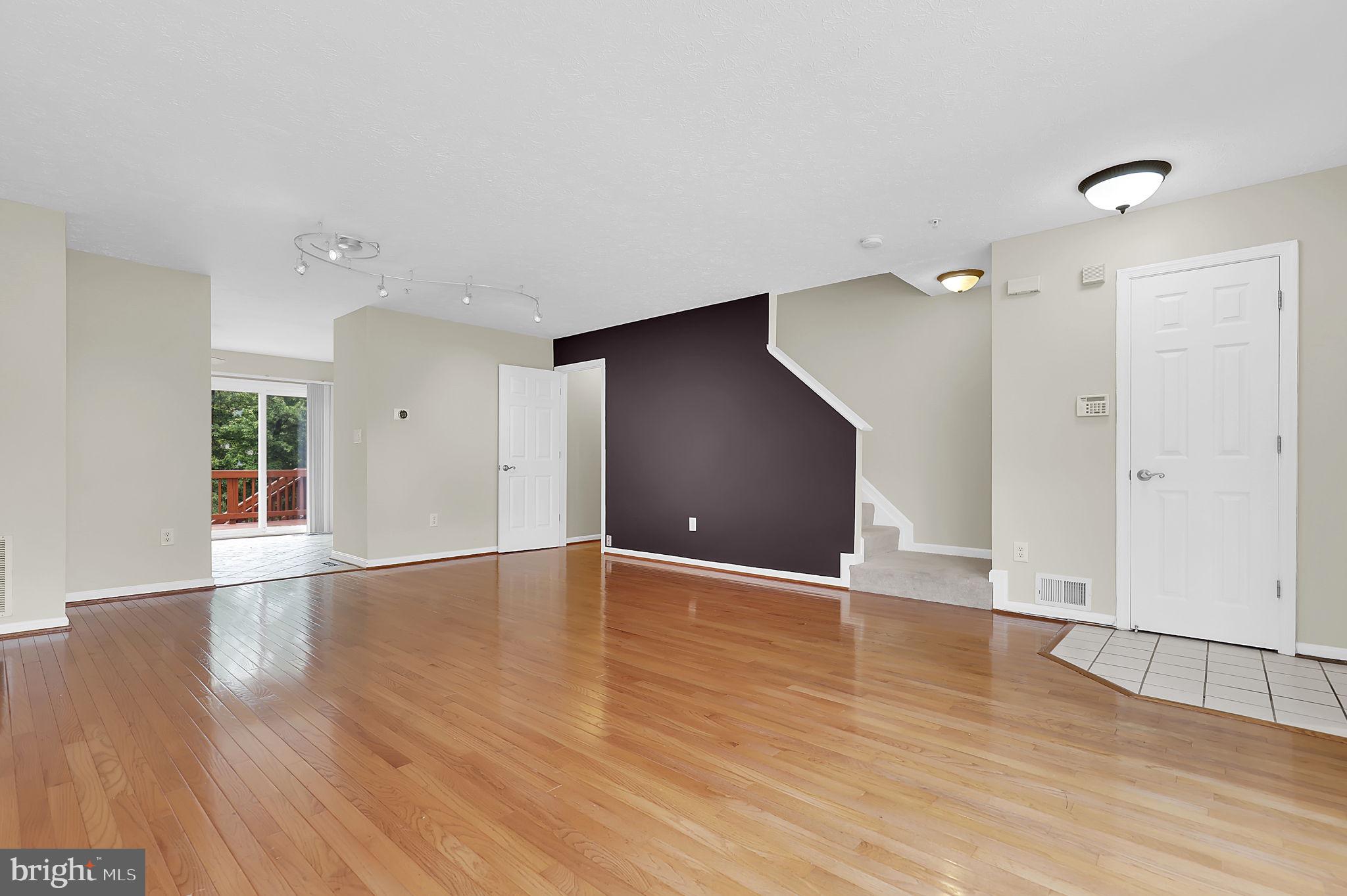 7150 Natures Road Columbia, MD 21046 - Photo 7 of 45 a view of an empty room with wooden floor and a window