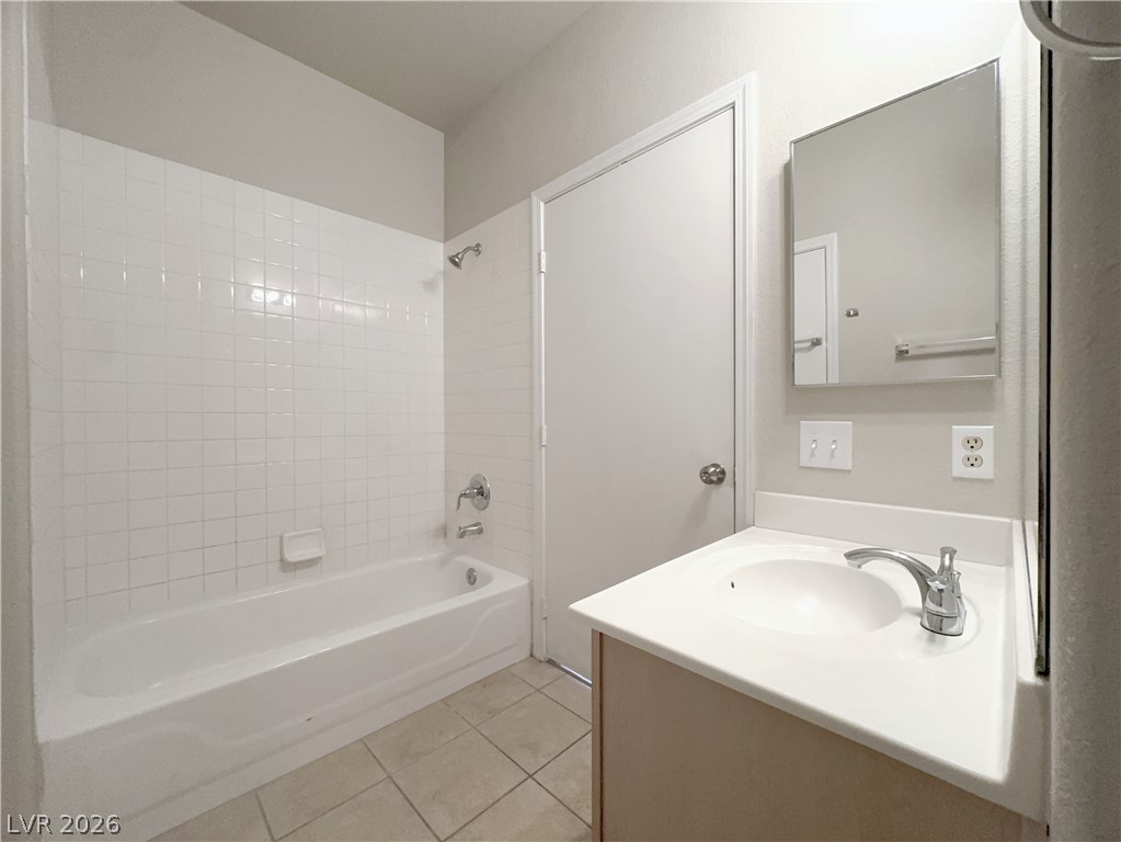 8725 West Flamingo Road, Unit 208 Las Vegas, NV 89147 - Photo 12 of 16 This bathroom features a sleek vanity and tiled flooring, offering both style and function.
