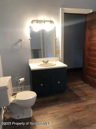 a bathroom with a toilet sink and mirror